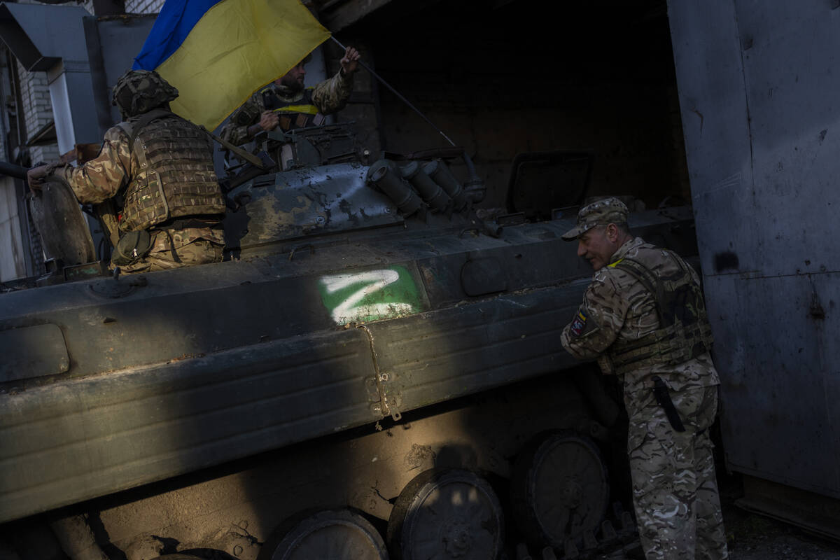 Ukrainian servicemen park a Russian BMP-2, an infantry combat vehicle, in the Kharkiv area, eas ...