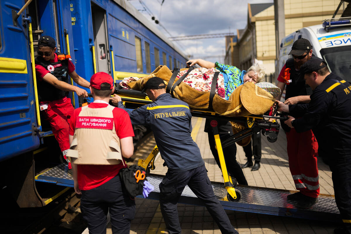 A patient is carried on a stretcher to board a medical evacuation train run by MSF (Doctors Wit ...
