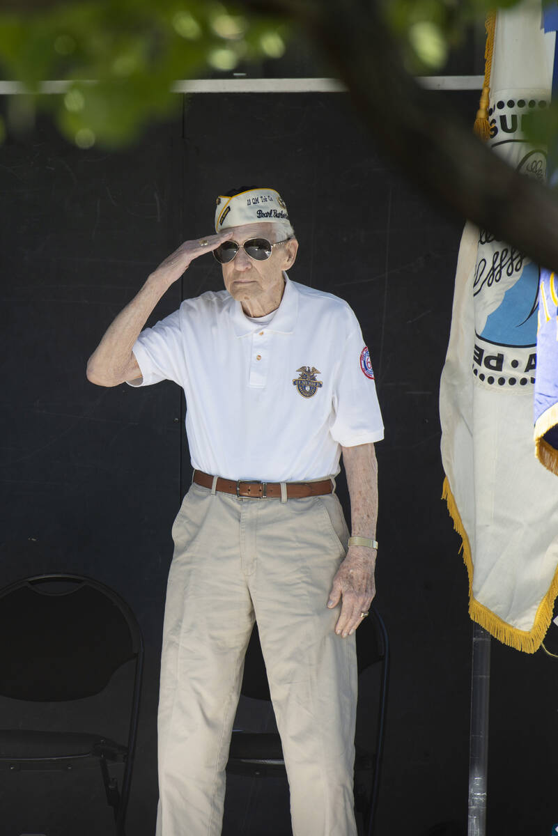 Ed Hall, a Pearl Harbor survivor, gives a salute during the ceremony at Lake Sahara South Park ...