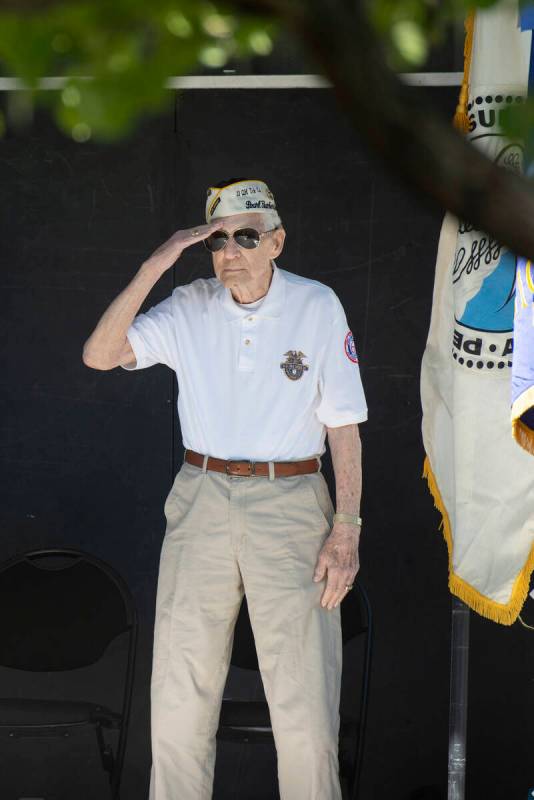 Ed Hall, a Pearl Harbor survivor, gives a salute during the ceremony at Lake Sahara South Park ...