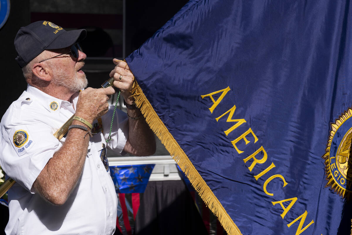 Marine Corps veteran Walter Cheatham unfurls the American Legion flag at Lake Sahara South Park ...