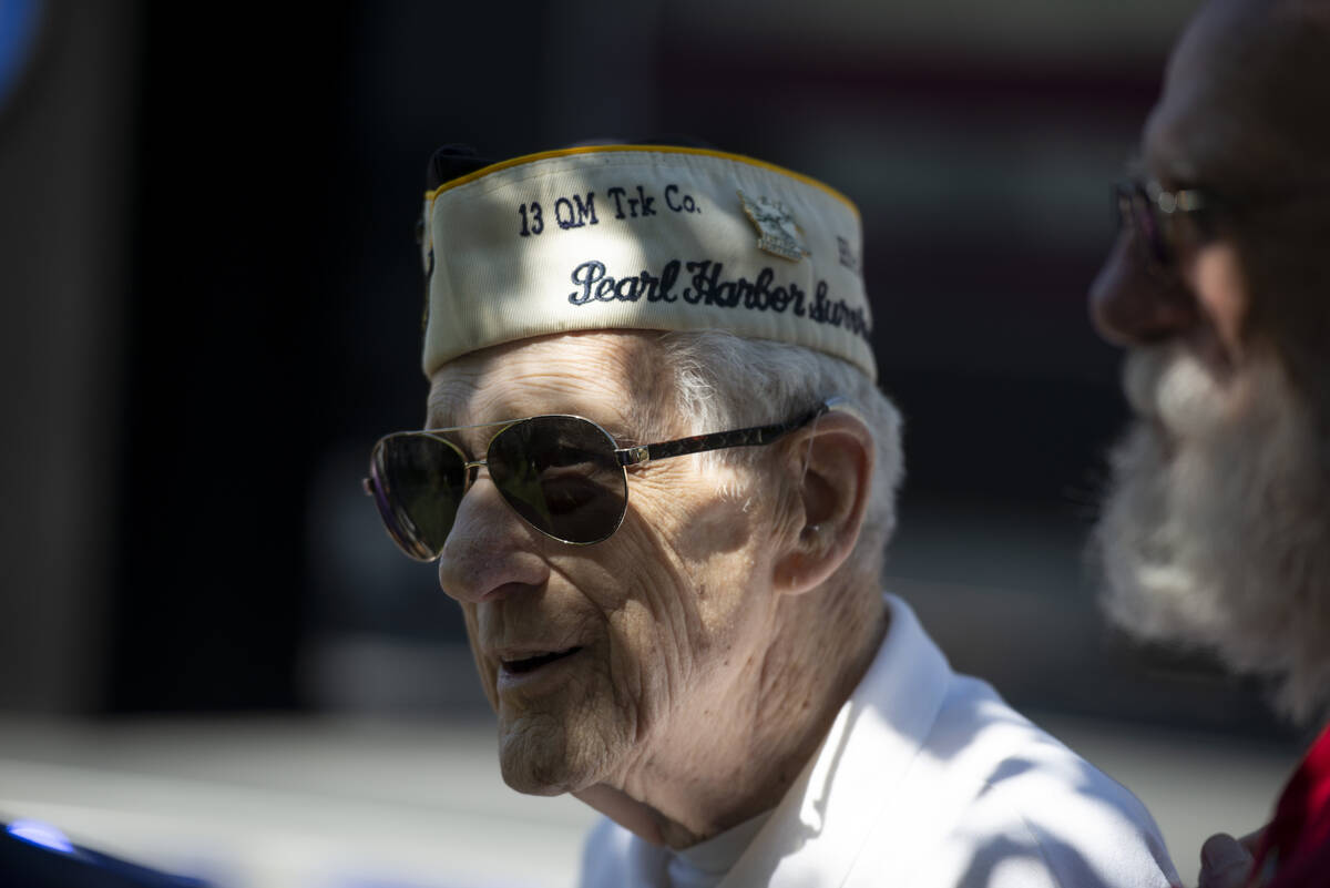 Ed Hall, a Pearl Harbor survivor, chats with attendees after the ceremony at Lake Sahara South ...