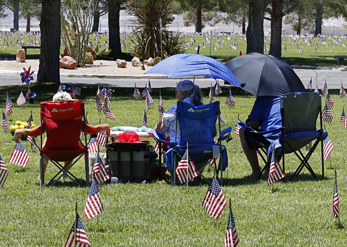 Laura West of Las Vegas, left, visits the grave of her grandfather U.S. Army veteran James Pric ...