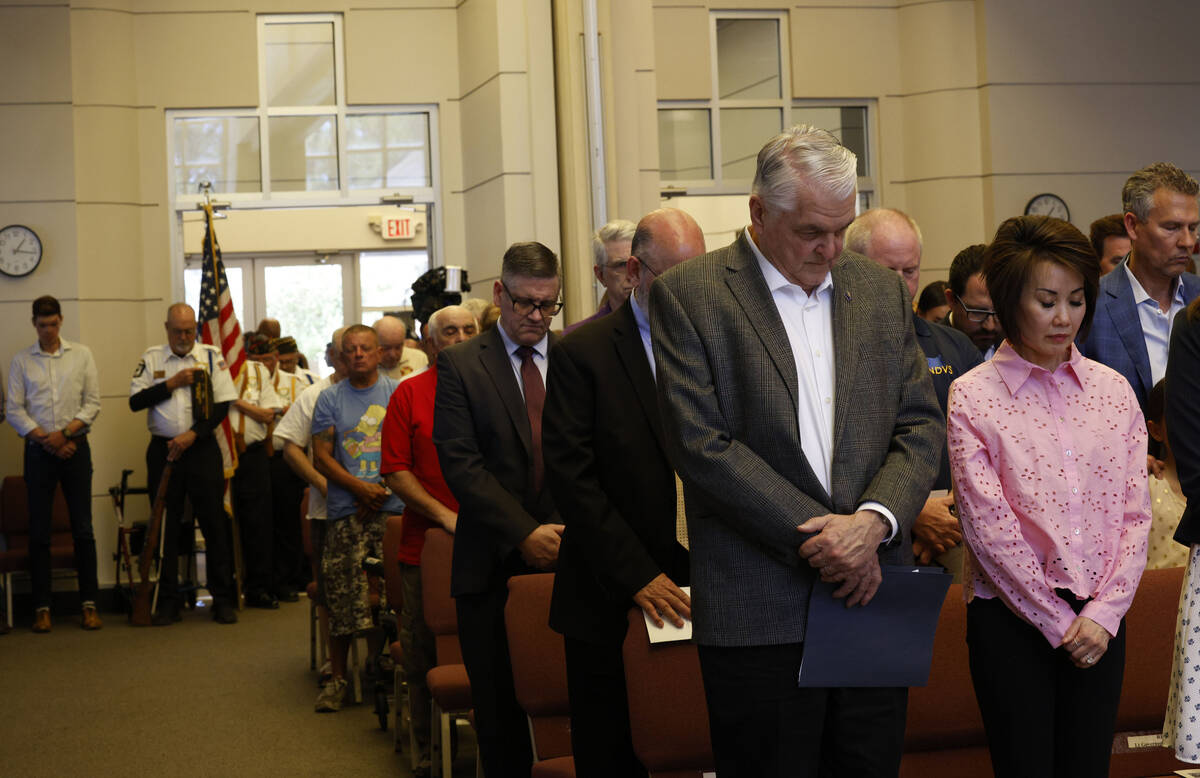 Gov. Steve Sisolak and his wife Kathy pray during a Memorial Day ceremony at Southern Nevada Ve ...