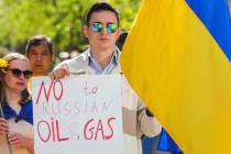 Ukrainian demonstrators demand an embargo on Russian oil during a protest in front of EU instit ...