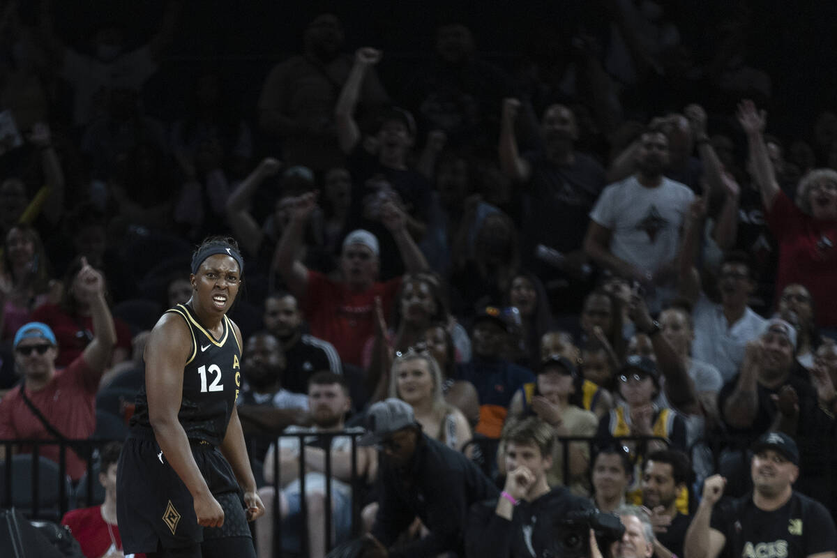 Las Vegas Aces guard Chelsea Gray (12) celebrates after scoring while the crowd cheers behind h ...