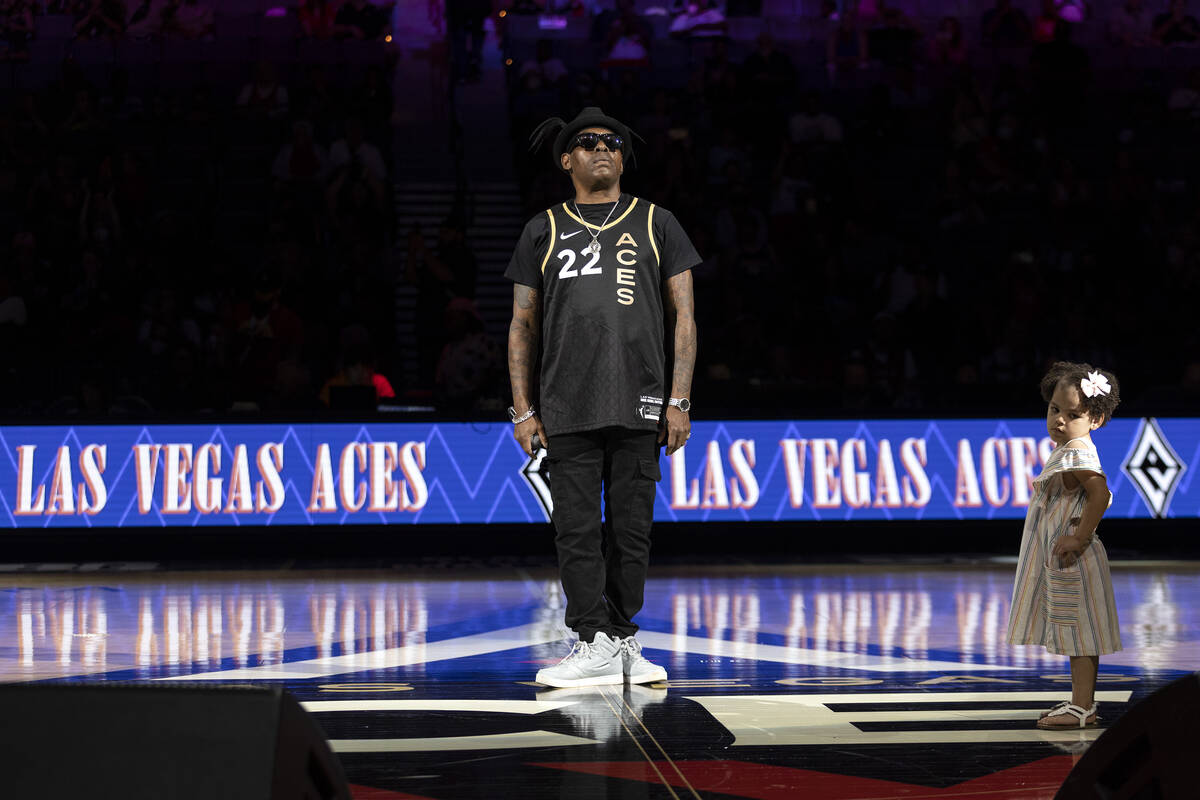 Coolio and his daughter react to applause after performing during halftime of a WNBA basketball ...
