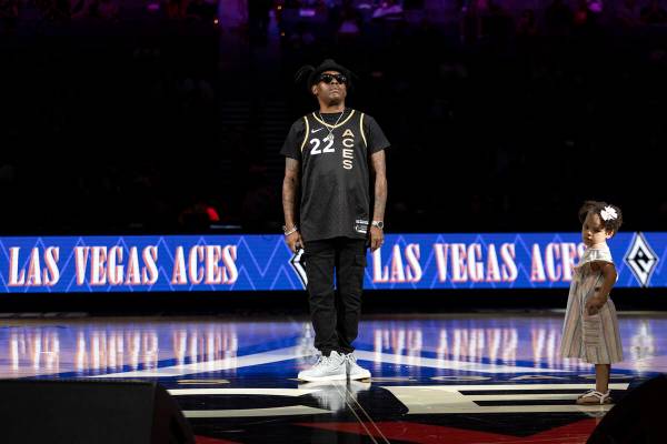 Coolio and his daughter react to applause after performing during halftime of a WNBA basketball ...
