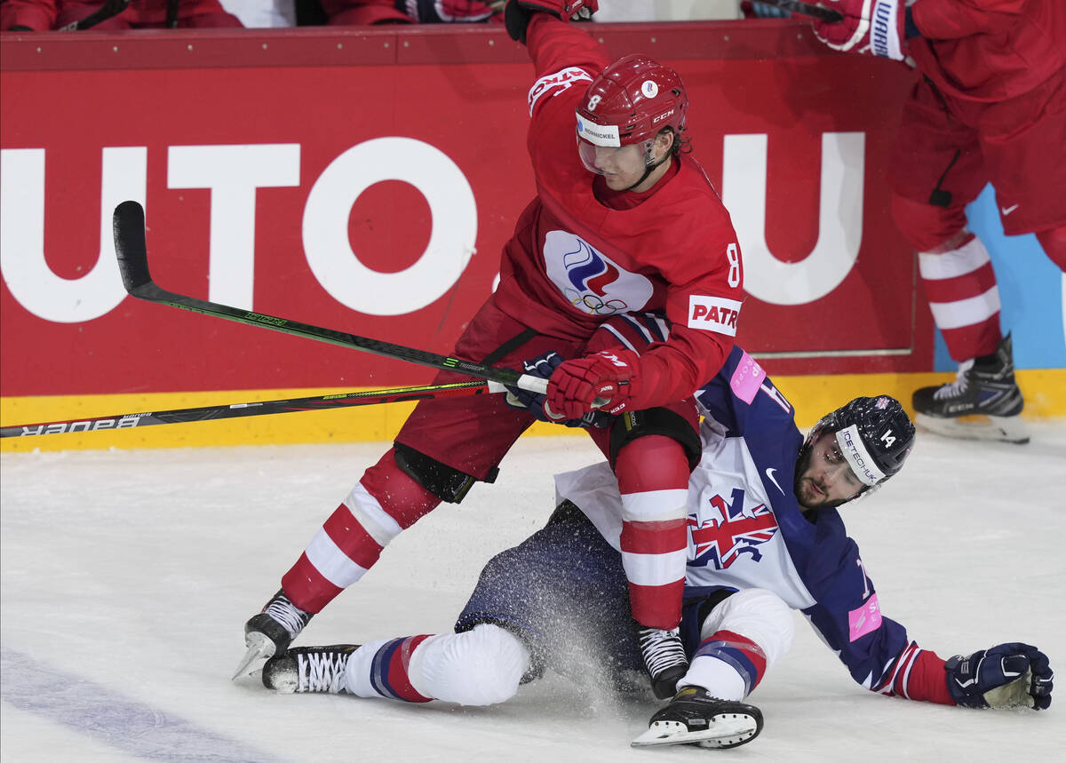 Liam Kirk of Great Britain, right, and Ivan Morozov of Russia fight for the puck during the Ice ...
