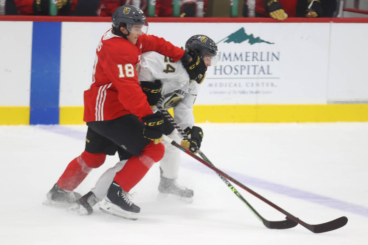 Vegas Golden Knights' Peyton Krebs (18) and Zach Dean (24) fight for the puck during rookie cam ...