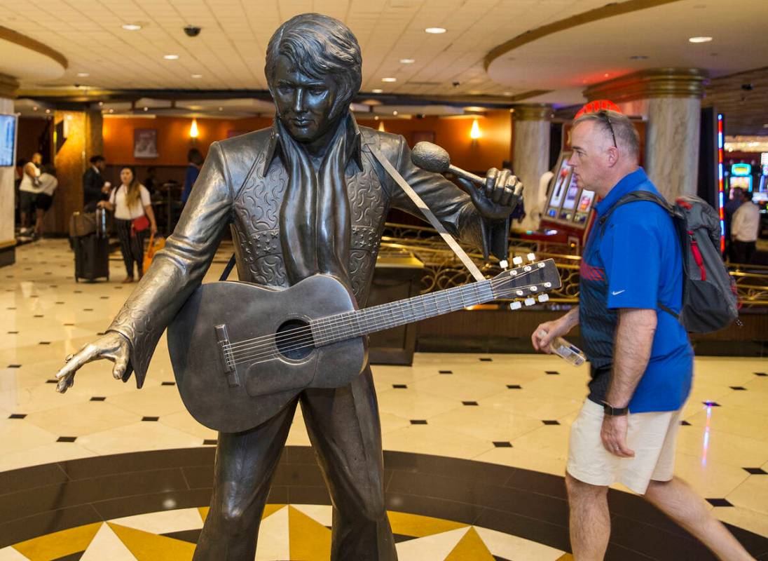 Guests pass by an Elvis Presley statue in the lobby of the Westgate in Las Vegas. (Benjamin Hag ...