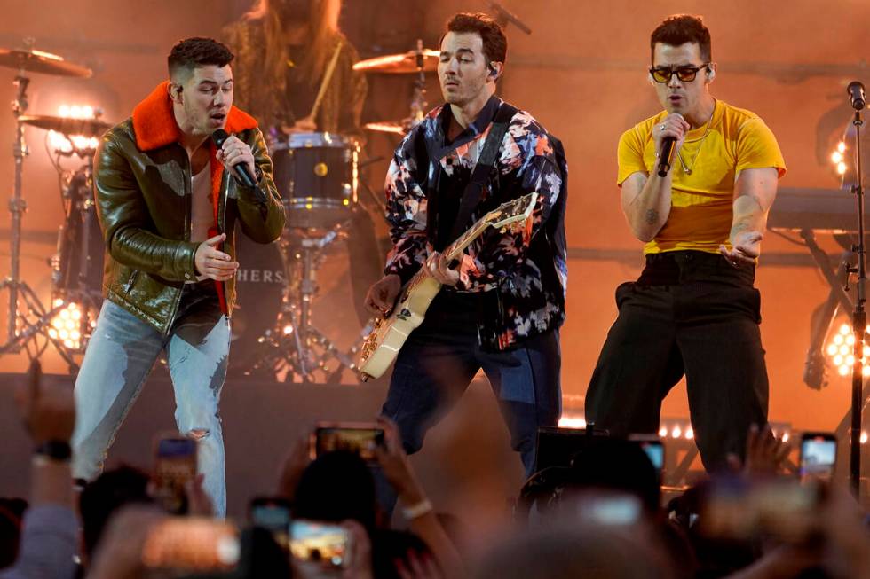 Nick Jonas, from left, Kevin Jonas and Joe Jonas, of the Jonas Brothers, perform at the Billboa ...