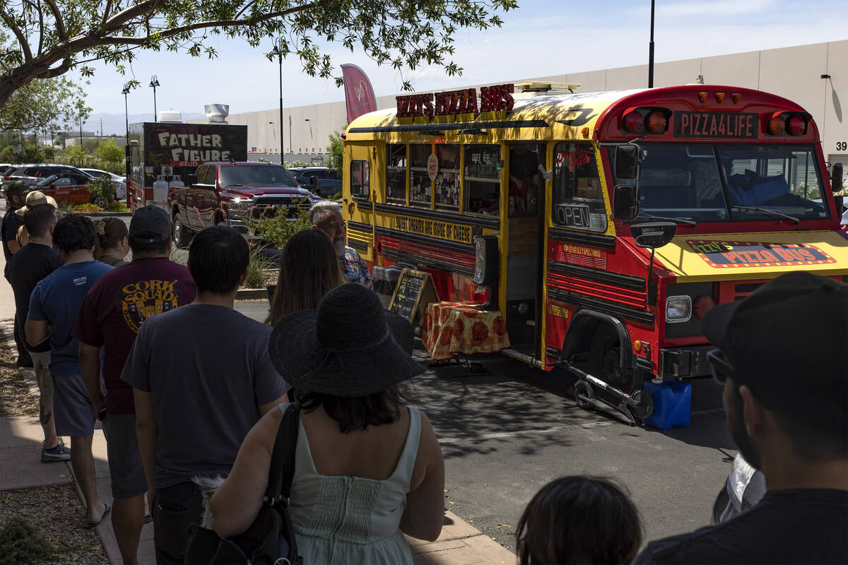 Patrons wait in line for Izzy’s Pizza Bus outside Vegas Valley Winery on Saturday, May 2 ...