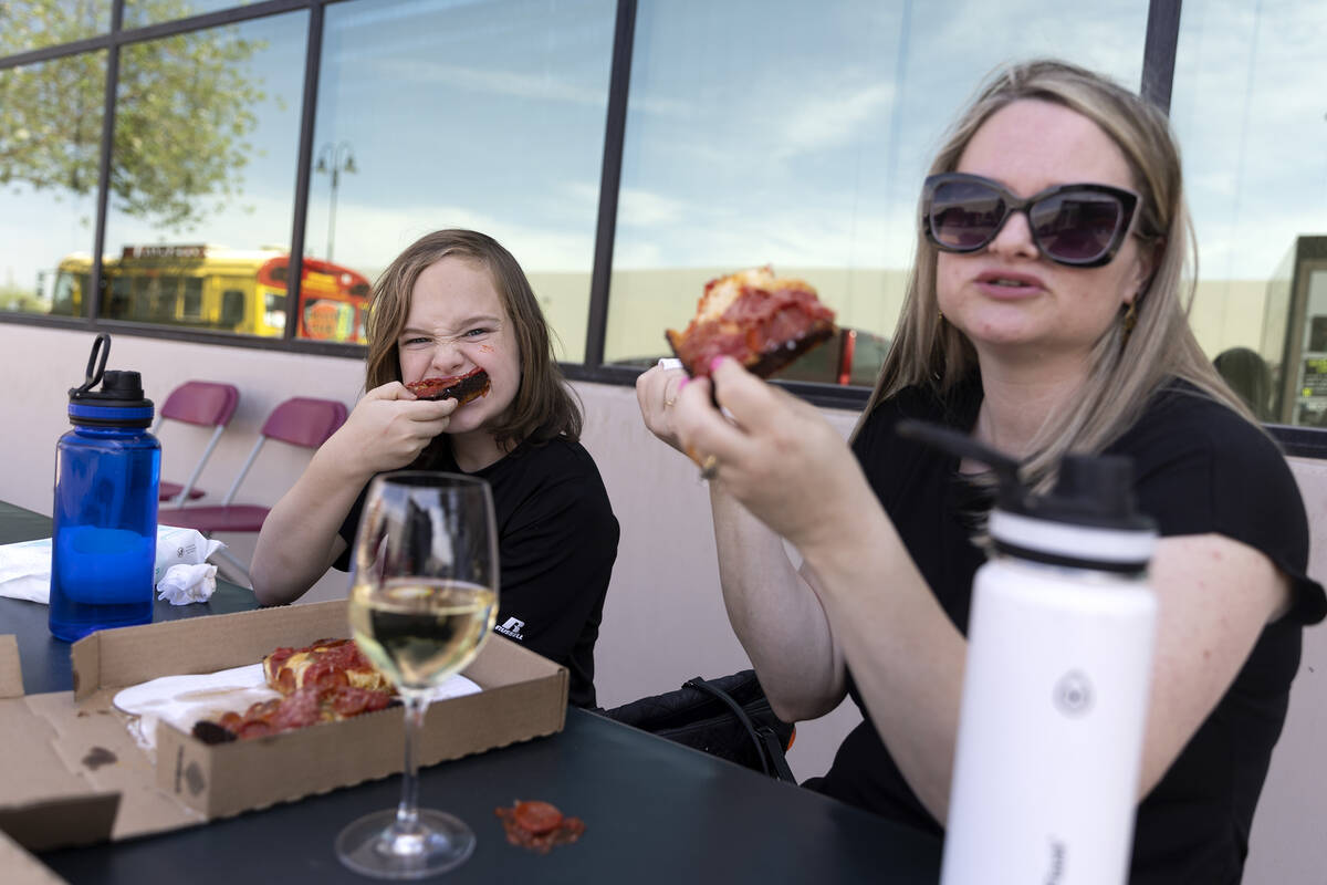 Drew Thompson, 10, and his mom Nicole Thompson, of Las Vegas, enjoy a Detroit-style pizza from ...