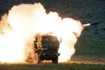 FILE - In this May 23, 2011, file photo a launch truck fires the High Mobility Artillery Rocket ...