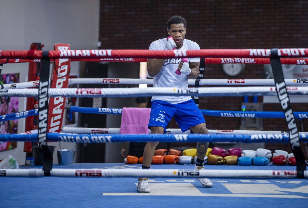 WBC lightweight boxer Devin Haney shadow boxes with hand weights in the ring during a workout s ...