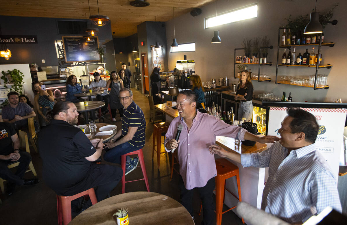 Luis De Santos, owner-operator of the Random Act Diner concept, center, introduces Freddie Palo ...