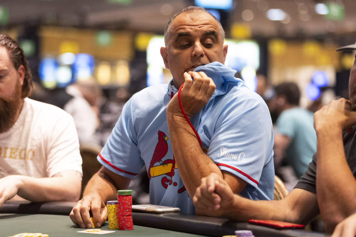Howard Mash of Fort Lauderdale, Fla., looks around the table while playing during the World Ser ...
