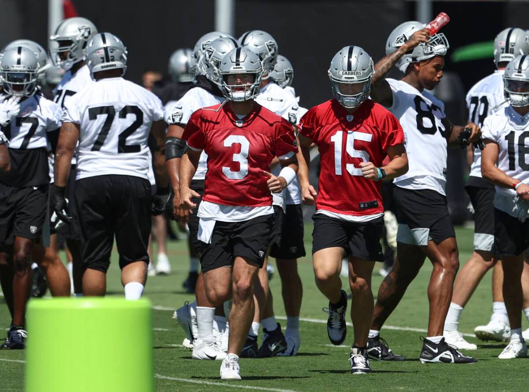 Raiders quarterbacks Jarrett Stidham (3) and Chase Garbers (15) participate during practice at ...