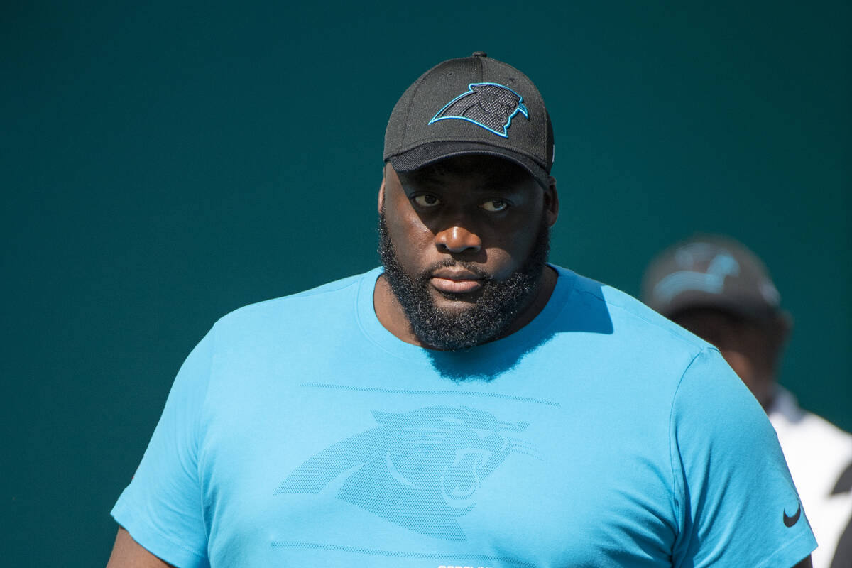 Carolina Panthers defensive line coach Frank Okam walks on to the field before an NFL football ...