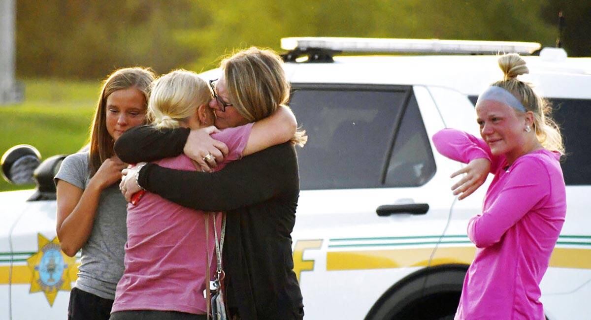 People console each other after a shooting at Cornerstone Church on Thursday, June 2, 2022 in A ...