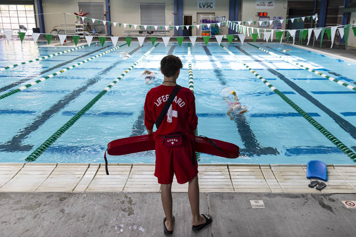 Aiden Ruggiutz, 18, a lifeguard, keeps an eye on swimmers at Pavilion Center Pool on Friday, Ju ...