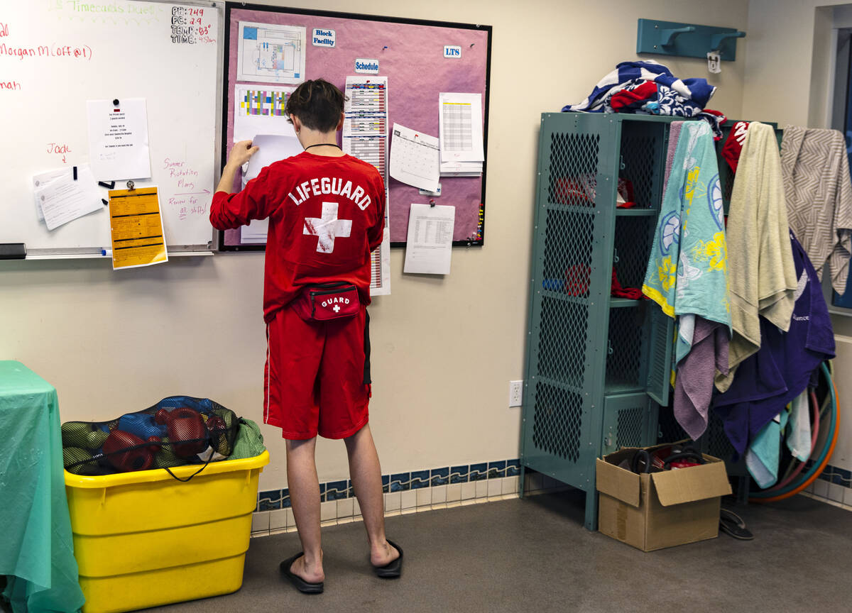 Aiden Ruggiutz, 18, a lifeguard, checks his schedule inside lifeguard shack at Pavilion Center ...