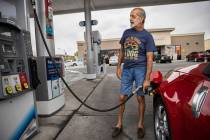 John Lasco pumps gas at Lucky Spot Chevron on Saturday, June 4, 2022, in Las Vegas. (Benjamin H ...
