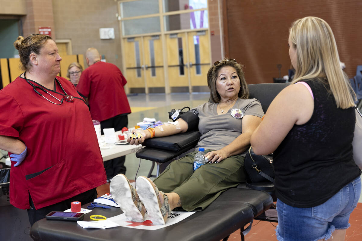 Joseph Landolfi’s grandmother, Rosie Landolfi, gives blood while chatting with Heather L ...