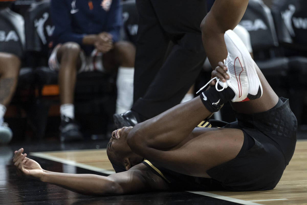 Las Vegas Aces guard Jackie Young (0) falls to the ground in pain during the second half of a W ...