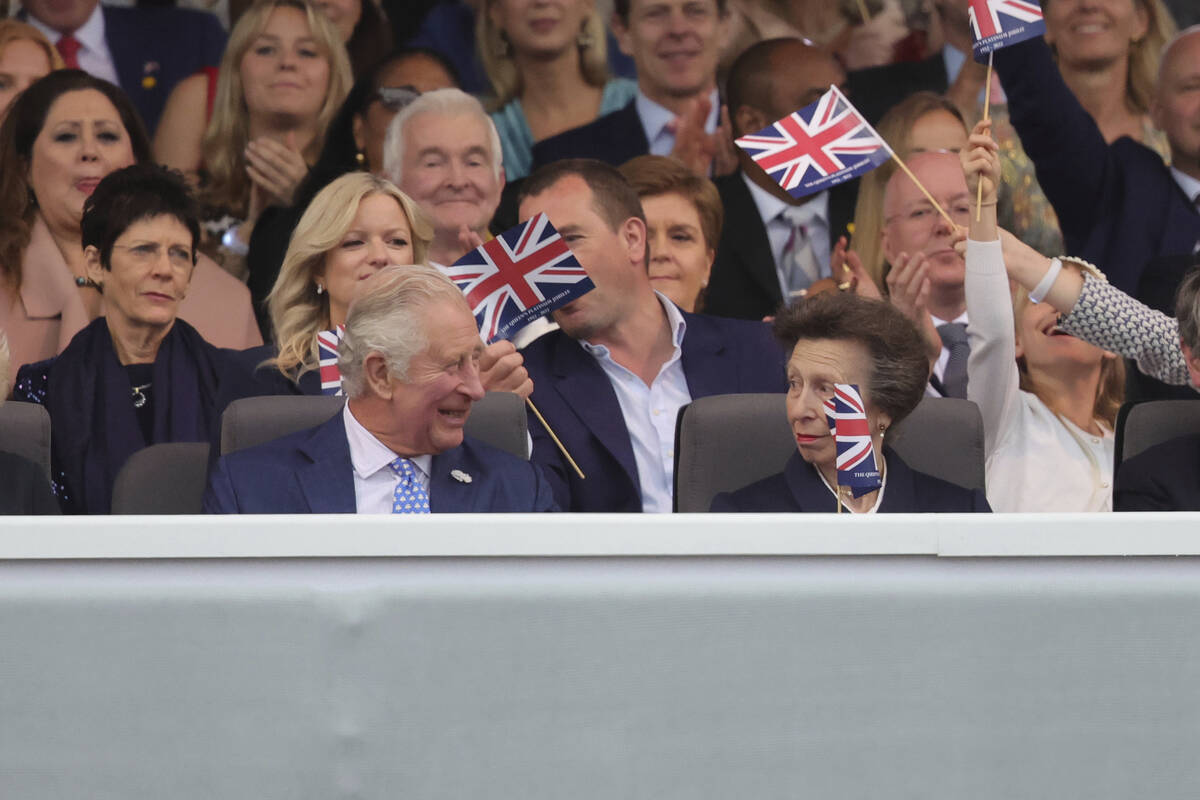 Prince Charles and Princess Anne watch the Platinum Jubilee concert taking place in front of Bu ...