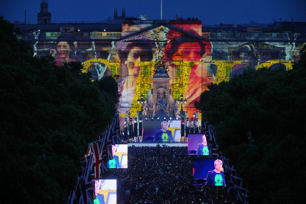 Images of Queen Elizabeth II are projected onto Buckingham Palace as Duran Duran perform during ...