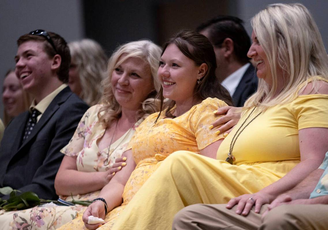 Jacob Closi, left, Jenn Closi, and Nicola Closi laugh during a funeral for their father and hus ...