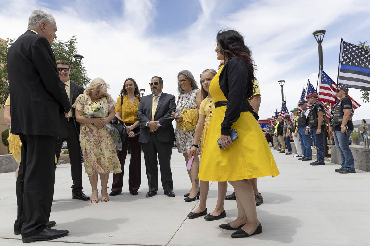 Gov. Steve Sisolak, left, greets the Closi family during a funeral for Officer Phil Closi, a Me ...