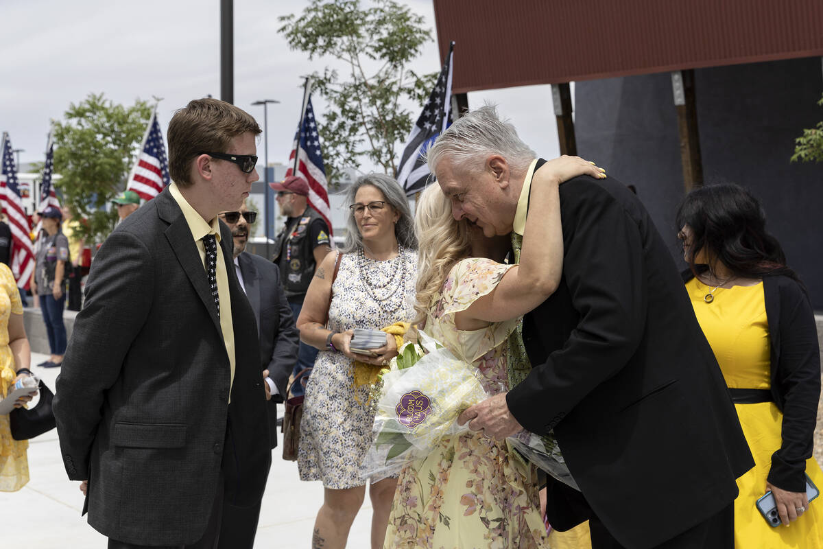 Gov. Steve Sisolak shares his condolences with Jenn Closi during a funeral for her husband Offi ...