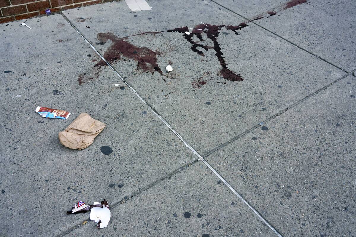 Blood is seen at the scene of a fatal overnight shooting on South Street in Philadelphia, Sunda ...