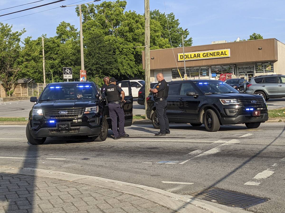 The Chattanooga Police Department stand near the scene following a shooting on Sunday, June 5, ...