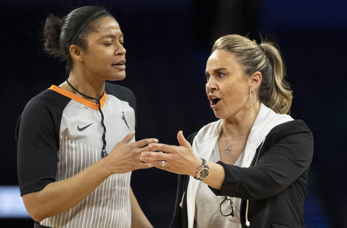 Aces head coach Becky Hammon, right, argues a call in the second half during a WNBA basketball ...