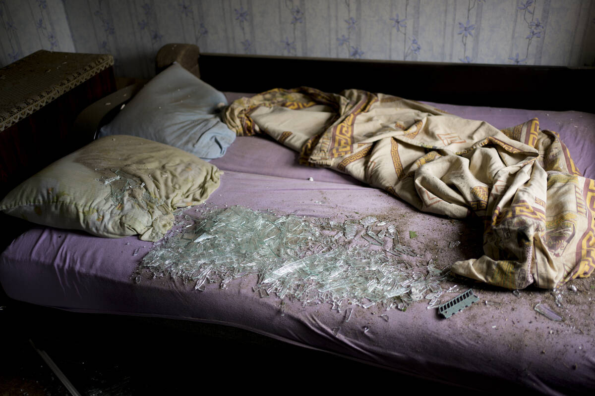 Shattered glass lies on the bed at a house damaged after a strike in Druzhkivka, Ukraine, Sunda ...