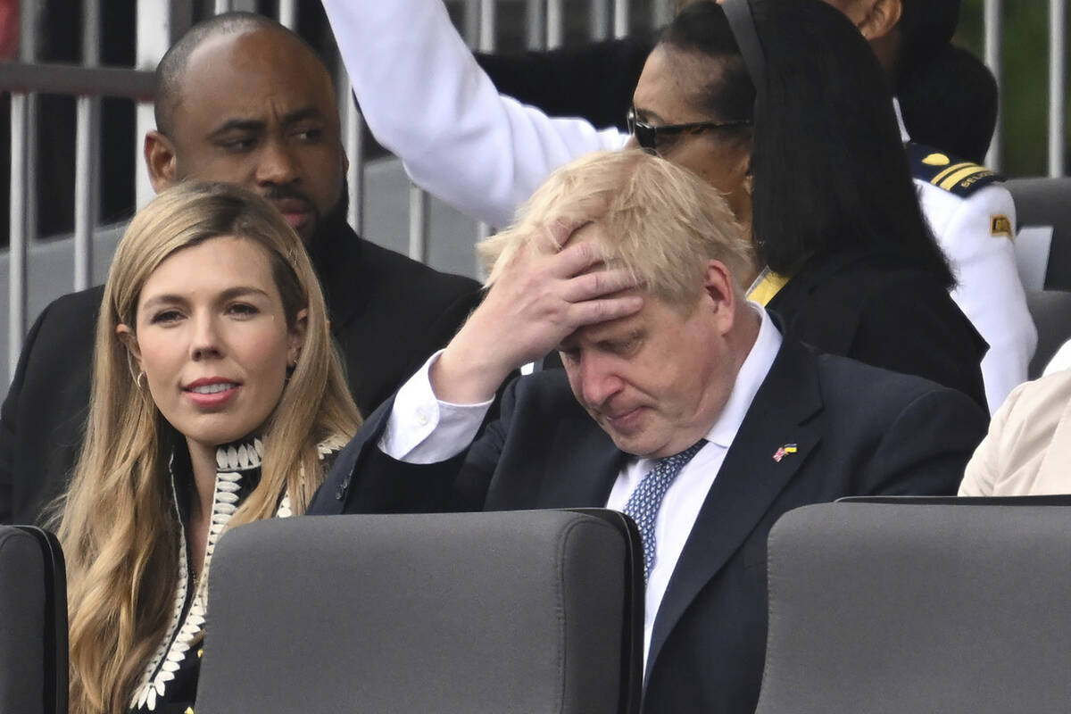 FILE - Britain's Prime Minister Boris Johnson and his wife Carrie, are seated during the Platin ...
