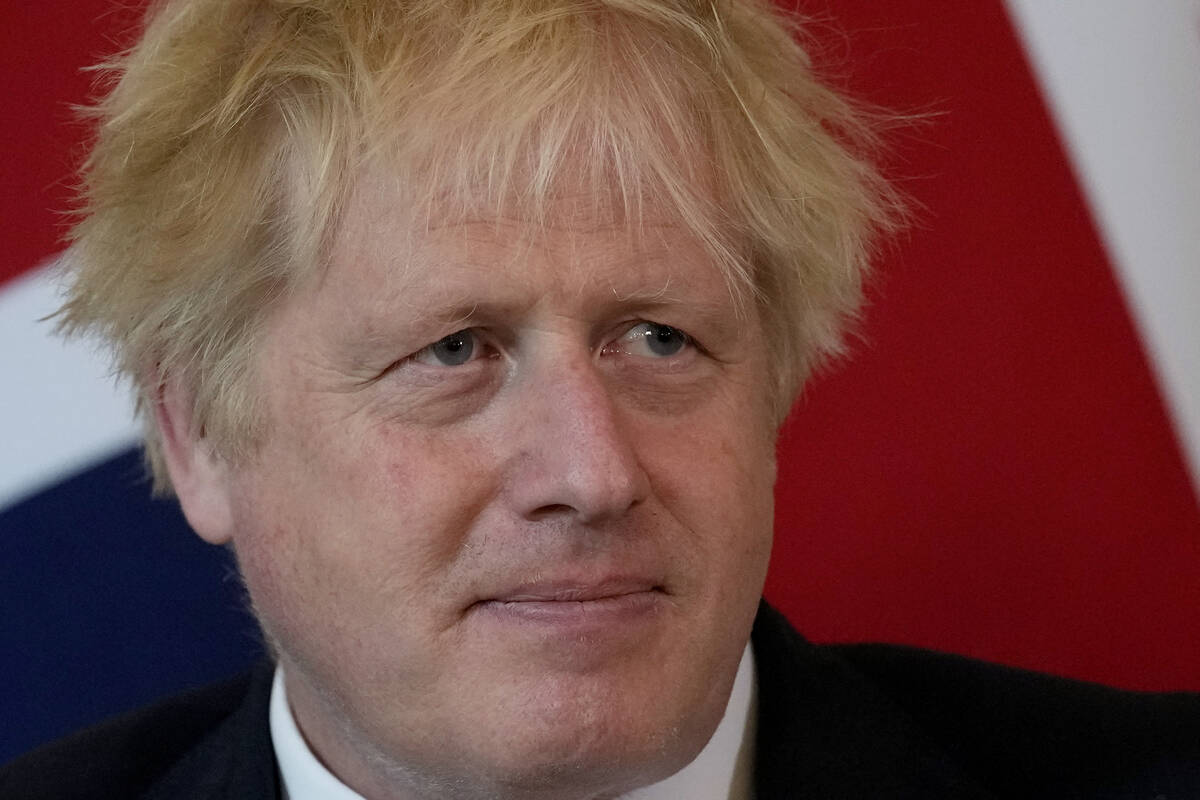 FILE - British Prime Minister Boris Johnson listens to the Amir of Qatar Sheikh Tamim bin Hamad ...