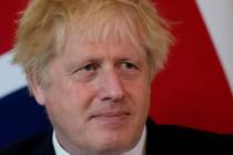 FILE - British Prime Minister Boris Johnson listens to the Amir of Qatar Sheikh Tamim bin Hamad ...