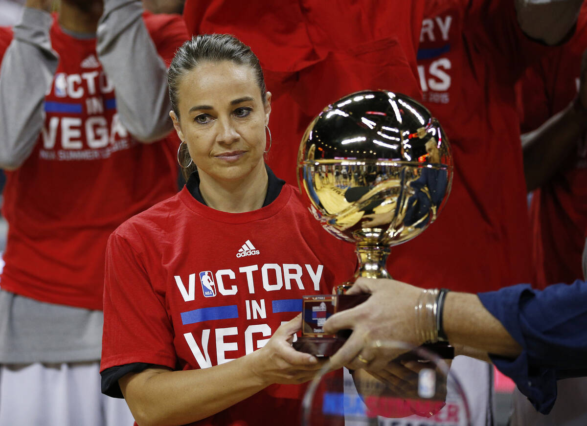 San Antonio Spurs coach Becky Hammon holds up the championship trophy after they defeated the P ...