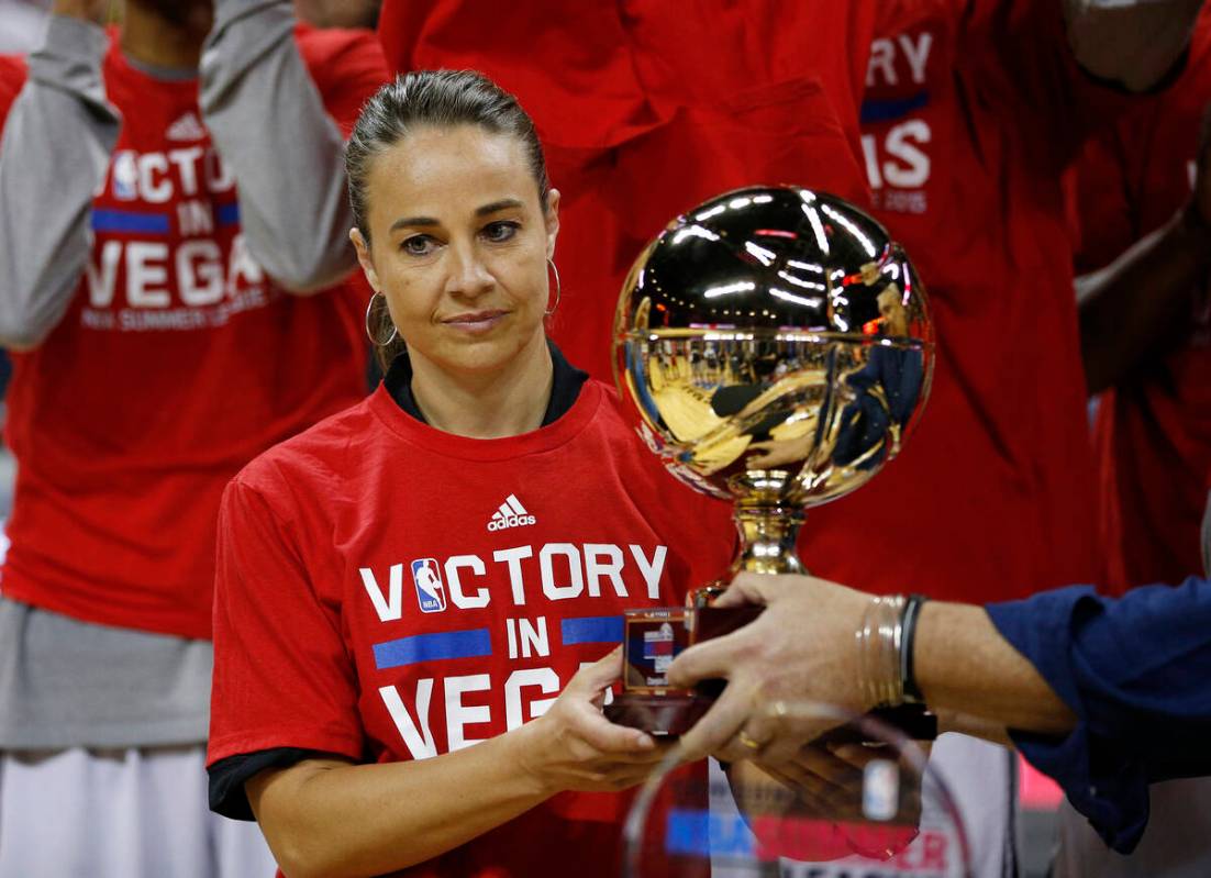 San Antonio Spurs coach Becky Hammon holds up the championship trophy after they defeated the P ...