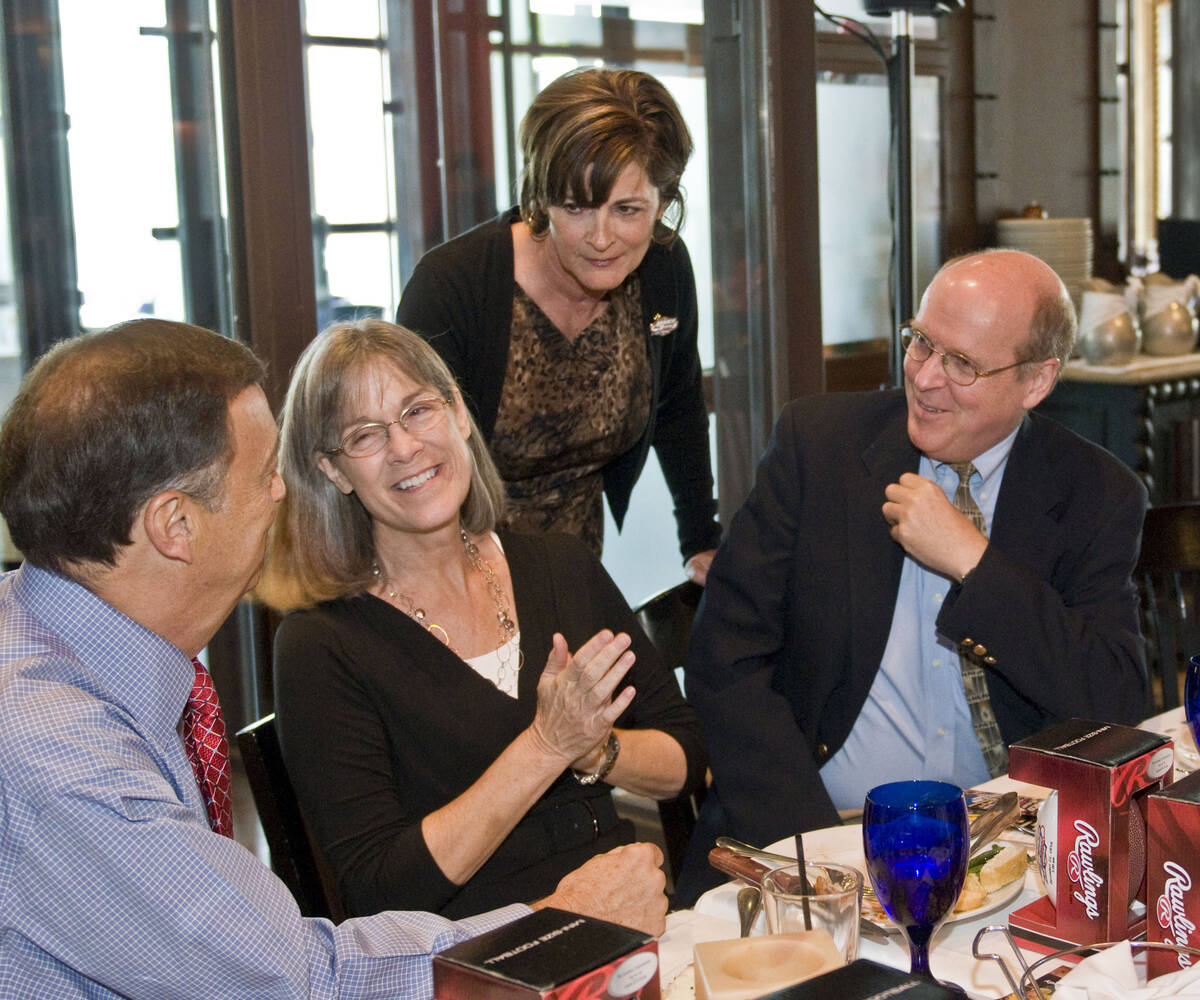 UNLV athletic director Jim Livengood, left, and his wife Linda, second left, chat with Tina Kun ...