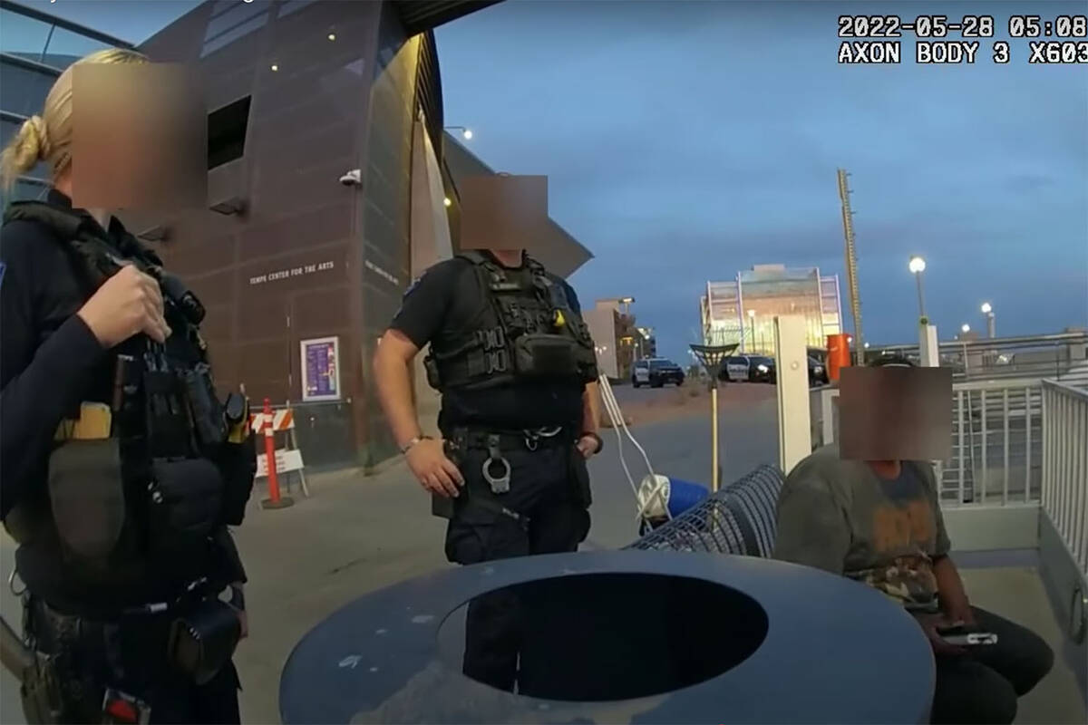 A screenshot from an officer's body camera shows two Tempe police officers talking to Sean Bick ...