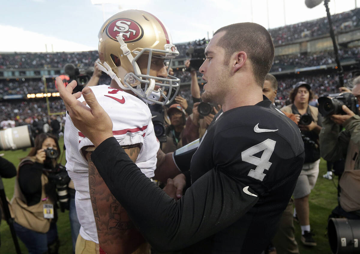 Oakland Raiders quarterback Derek Carr (4) greets San Francisco 49ers quarterback Colin Kaepern ...