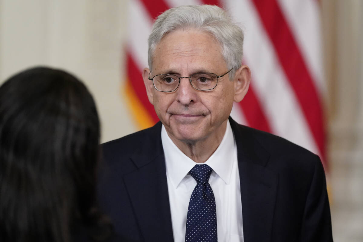 Attorney General Merrick Garland talks to people before President Joe Biden signs an executive ...