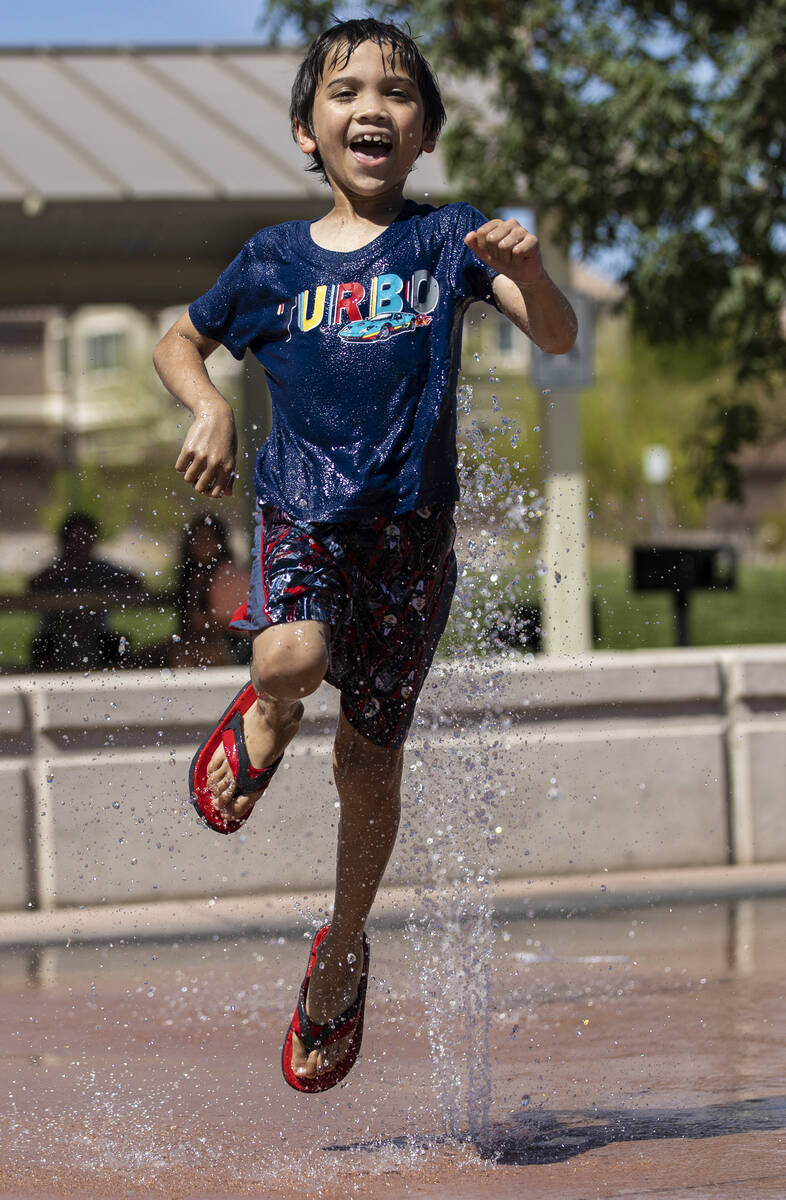 Zac Harris, 8, visiting from Kansas City, Mo., plays in the water at Trigono Hills Park on Wedn ...