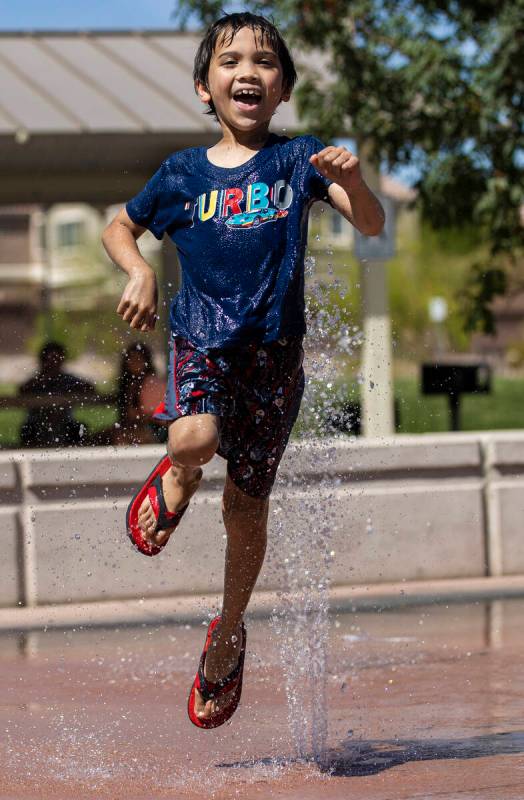 Zac Harris, 8, visiting from Kansas City, Mo., plays in the water at Trigono Hills Park on Wedn ...